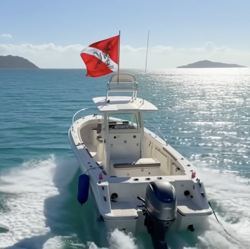 No Tops Nation diver down flag flying on a center console boat during a day on the water, illustrating the history of the dive flag and boating safety.